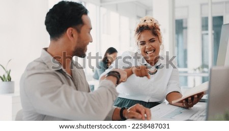 Laptop, success or happy employees fist bump in celebration of sales goals or target at office desk. Support, mission or woman celebrates partnership growth, team work or achievement with worker