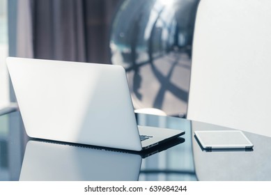 Laptop And Tablet On Glass Work Desk