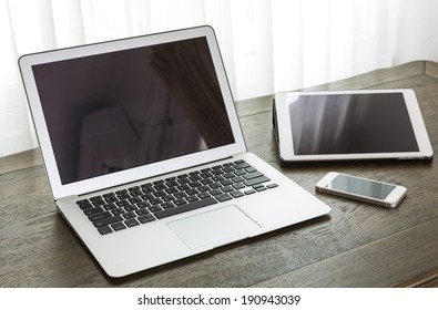 Laptop With Tablet And Smart Phone On Table