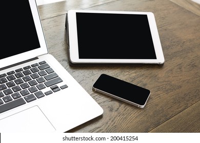 Laptop With Tablet And Smart Phone On Table