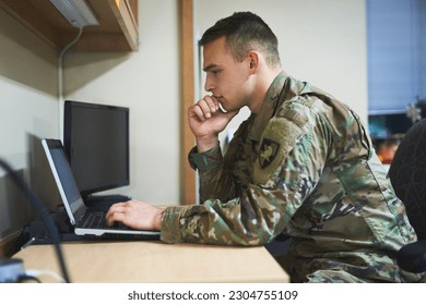 Laptop, thinking and military man with security software, online research and law academy in office. Planning, soldier or young army person on computer, internet search or website information check - Powered by Shutterstock