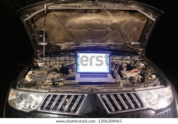 Laptop torque figures and horsepower is the\
engine of the vehicle for diagnostics and configuration. Diagnostic\
machines is ready for use with the car. Broken car in auto repair\
shop. Auto service.