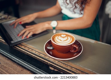 Laptop, Typing And A Freelance Woman With Coffee In Cafe, Writing An Email Or Doing Internet Research On Blog. Freelancer, Writer Or Author Working On Online Project In Coffee Shop, Hands On Keyboard