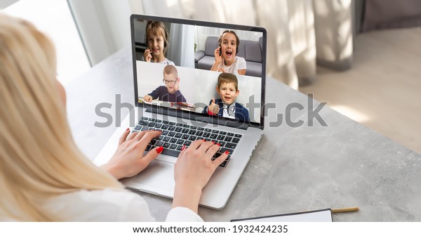 laptop with videoconference children classmates\
stands on the table