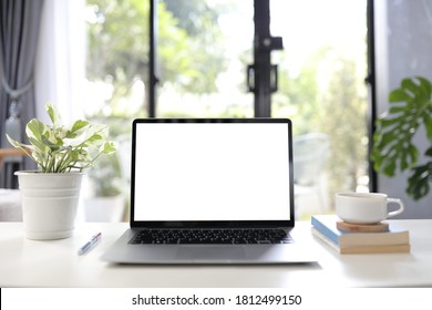 Laptop With White Blank Screen With Coffee Cup And Books Cozy Home Office 
