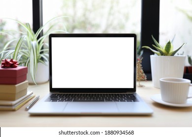 Laptop with white coffee cup and gift box - Powered by Shutterstock