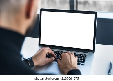 Laptop with white screen, behind which the person works - Powered by Shutterstock