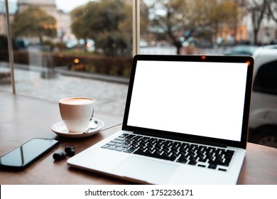 Laptop With White Screen In Cafe Table Near Window