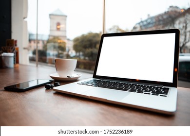 Laptop With White Screen In Cafe Table Near Window