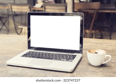 laptop with white screen on a table in a cafe, mock up