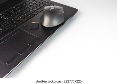 Laptop with wireless mouse and memory SD card - EDC everyday carry - empty space - white background - Powered by Shutterstock