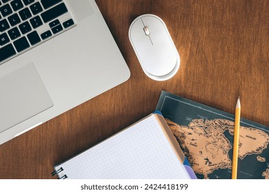 Laptop, World map and notebook on a wooden table, top view. - Powered by Shutterstock