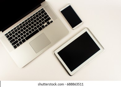 A Laptop,a Tablet Computer And A Mobile Phone(cell Phone)