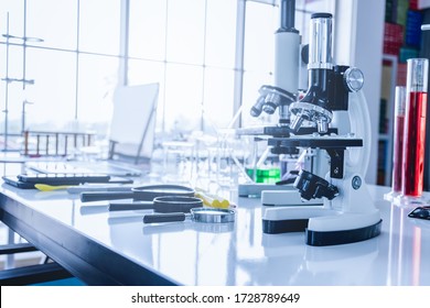 Laptops, smartphones, microscopes, beakers, test tubes, and scientific laboratory equipment in scientific laboratories.