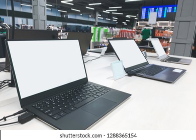 Laptops With A White Screen At The Showcase In The Electronics Store. Buy A Laptop In A Technology Store.