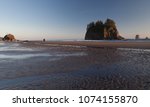 LaPush, Washington state, USA - distant couple walking on the Second Beach during golden hour, 