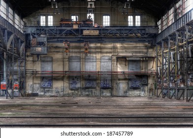 Large abandoned hall with an old crane