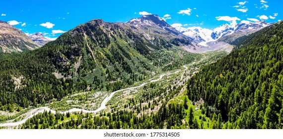 large aerial of engadin mountains/ morteratsch switzerland during summer with trees and mountains in background