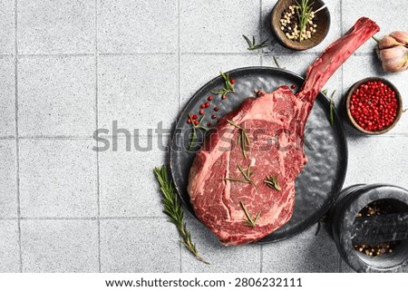 Large aged beef steak on the bone. Premium raw Tomahawk steak. Top view.