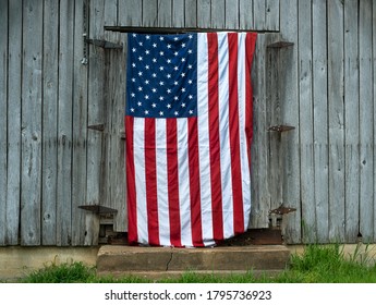 Large American Flag Hanging On Old Gray Wooden Barn Doors In Rural Country, Values, Patriotism, Patriotic, Nation, Country Folk, Farm, Conservative, Republican, Election