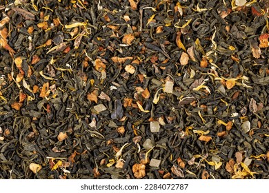 A large amount of dry green tea with pieces of fruit, delicious and fragrant green tea with a pleasant aroma - Shutterstock ID 2284072787