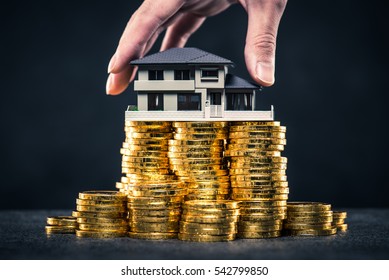 A large amount of money and house model - Shutterstock ID 542799850