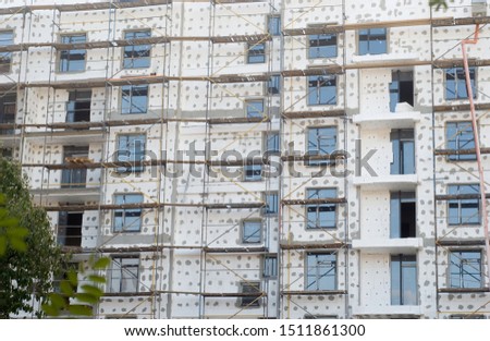 The large apartment building is sheathed with plasterboard