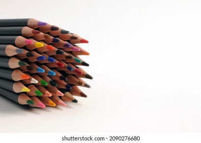 A large assortment of colored watercolor pencils on a white background with an inscription field