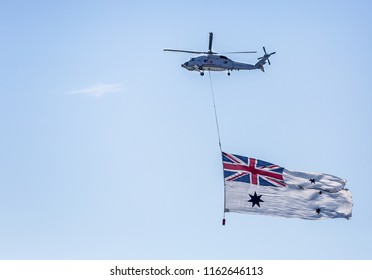 Large Australian Flag Being Flown Below Australian Airforce Helicopter In Sydney, NSW, Australia On 4 October 2013