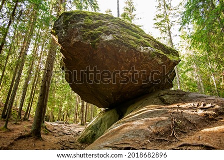 A large balancing boulder rock called Kummakivi in Finnish nature near Ruokolahti
