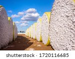 Large bales of cotton wrapped in yellow plastic waiting for processing at an Emerald, Queensland cotton gin.