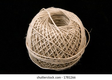 A Large Ball Of Neatly Wound String On A Black Background.