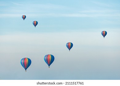 Large balloons float against the background of the blue sky. The concept of aeronautics.