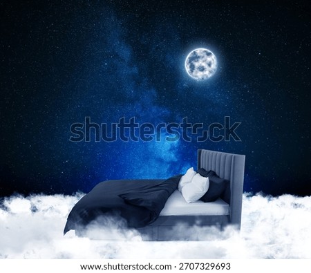 Large bed on fluffy clouds in starry night sky