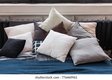 A Large Bed On Which Lie Many Different Pillows