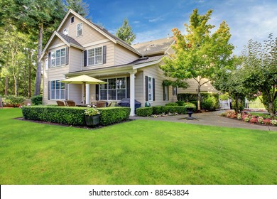 Large Beige House With Green Grass