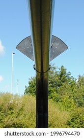 Large Black Industrial Pipe with Fan Shaped Anti Climb Device seen against Blue Sky 