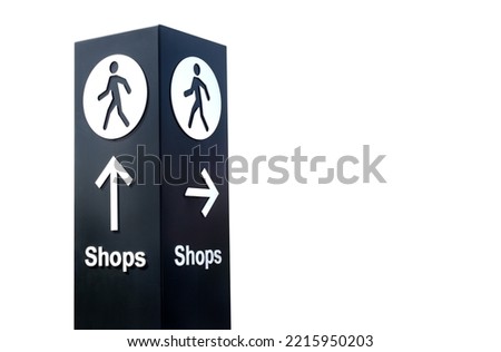 Large black and white free standing directional sign post with arrow and pedestrian icon pointing towards shops. Isolated on white background.