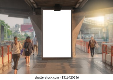 Large Blank Advertise Billboard White LED Screen Vertical On Big Concrete Pole Walk Way Outdoor In City With People Walking Go To Working On Morning.