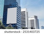 Large blank advertising billboard on modern building against clear blue sky. Ads mockup.