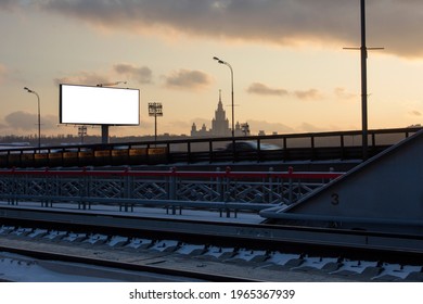 Large Blank Billboard For Advertising. Silhouette Of Moscow State University At Sunset. View From Berezhkovsky Bridge. Frosty Winter Day. Moscow, Russia.