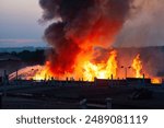 Large blaze at burning industrial building.