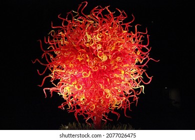 A Large, Blown Glass Ball Or Fire-like Colors