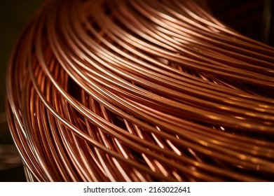 Large bobbin of orange copper wire in light warehouse