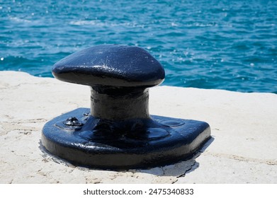 large bollard on the shore in the sunlight - Powered by Shutterstock