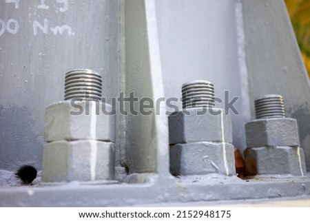 A large bolt holds the base of the high voltage pole.