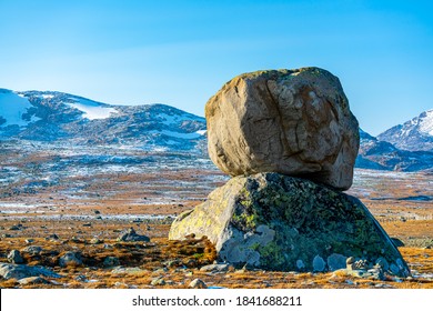 Large boulder from the ice age sitting on top of another boulder in a beautiful natural phenomenon. 