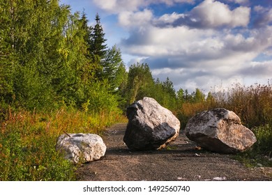 Large Boulder Stones Block The Forest Road Summer Landscape.