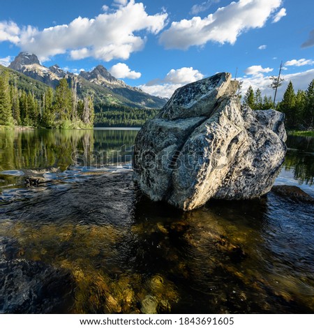Large Boulder in Taggart Lake with smooth water