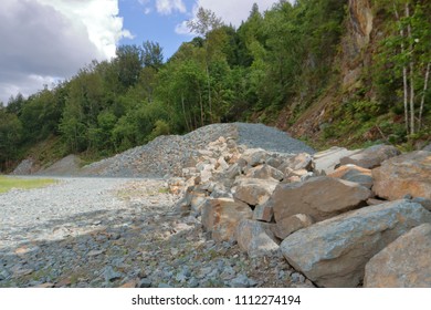 Large boulders, rocks and stones are used to create an abutment near a steep rocky slope where there is a risk of landslides.  